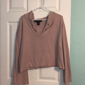 pink sweatshirt, sleeves flare out